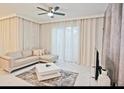Cozy living room with a comfortable sectional sofa, neutral decor, and lots of natural light at 9061 Dogleg Dr, Davenport, FL 33896