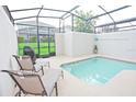 Relaxing screened-in pool area with lounge chairs, providing a private outdoor retreat at 9061 Dogleg Dr, Davenport, FL 33896