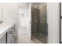 Bright bathroom with a glass-enclosed shower, a double vanity with ample counter space, and neutral tile at 9108 Wildlight, Wildwood, FL 34785