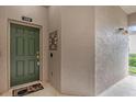 Inviting front door with a welcoming mat, doorbell and security features at 9435 Myrtle Creek Ln # 308, Orlando, FL 32832