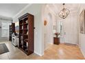 Warm and inviting foyer featuring tile flooring, a stylish chandelier, and elegant archway at 106 Mist Flower Ln, Groveland, FL 34736