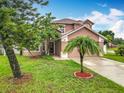 Charming two-story home featuring well-maintained landscaping and a welcoming entrance at 12300 Abberton Ct, Orlando, FL 32837