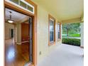 Inviting entryway with an open door, showcasing wood floors and light-filled spaces at 13055 Overstreet Rd, Windermere, FL 34786