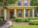 Charming two-story home with a well-manicured lawn and a welcoming front porch at 13055 Overstreet Rd, Windermere, FL 34786