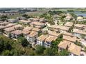 An aerial view showcasing a neighborhood with well-maintained homes, lush landscaping, and beautiful green spaces at 1327 Shinnecock Hills Dr, Davenport, FL 33896