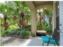 Cozy patio featuring a comfortable chair and lush greenery, perfect for relaxing outdoors and enjoying serene garden views at 1327 Shinnecock Hills Dr, Davenport, FL 33896