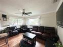 Comfortable living room with hardwood floors, a ceiling fan, and plantation shutters at 1400 Yates St, Orlando, FL 32804
