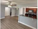 Spacious living room with new flooring and access to kitchen and bedroom at 190 Riverbend Dr # 102, Altamonte Springs, FL 32714
