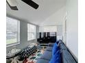 Bright living room featuring plush seating, large windows and unique ceiling fan at 211 N Randolph Ave, Kissimmee, FL 34741