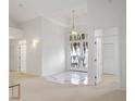 Bright foyer with high ceilings, decorative doors, and marble accents at 235 Promenade Cir, Lake Mary, FL 32746