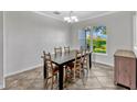 Bright dining room with a large window and a stylish chandelier at 2681 Cabernet Cir, Ocoee, FL 34761