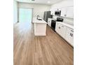 Open concept kitchen featuring modern appliances, an island, and lots of counter space at 319 Anchovie Ct, Poinciana, FL 34759