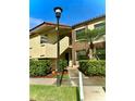 Inviting two-story condo building with lush landscaping and visible unit numbers at 3207 Westridge Blvd # 104, Orlando, FL 32822