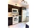 Efficient kitchen layout with ample cabinet space and white appliances at 3207 Westridge Blvd # 104, Orlando, FL 32822