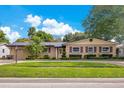 Charming single-story home with a manicured lawn and lush landscaping at 3405 Werber St, Orlando, FL 32806