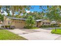 Charming home with a two-car garage, lush landscaping, and a well-manicured lawn at 3405 Werber St, Orlando, FL 32806