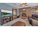 Cozy living room featuring a brick fireplace, plush seating, and a built-in display cabinet at 3405 Werber St, Orlando, FL 32806