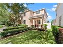 A charming two-story home boasts lush green grass, vibrant landscaping, and a sunny facade at 3426 Schoolhouse Rd, Harmony, FL 34773