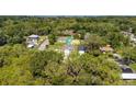 An aerial view of a home with lush surroundings and mature trees, showcasing the property's setting at 3678 Rollin O Ln, Apopka, FL 32703