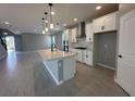 Modern kitchen featuring a large island, stainless steel appliances, and sleek white cabinetry at 5324 Center Lake Ranch Blvd, St Cloud, FL 34771