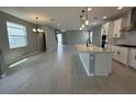Open-concept living space with hardwood floors, recessed lighting, and abundant natural light at 5324 Center Lake Ranch Blvd, St Cloud, FL 34771