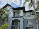 Close up view of a two-story condo building with balconies, showcasing the architectural details and outdoor living space at 5501 Pga Blvd # 4723, Orlando, FL 32839