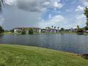 Scenic water view of condos, featuring the community's tranquil lake and lush landscaping at 5501 Pga Blvd # 4723, Orlando, FL 32839