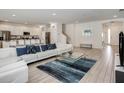 Open-concept living room with tile floors, a large sofa, and a view of the kitchen at 6112 Broad Oak Dr, Davenport, FL 33837