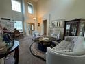 Living room with soaring ceilings, decorative furnishings, and dining area adjacent at 6224 Zane Dr, Mount Dora, FL 32757