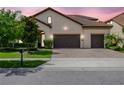 Charming single-story home with a terracotta roof, lush landscaping, and a spacious three-car garage at 8047 Chilton Dr, Orlando, FL 32836