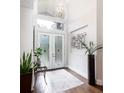 Bright foyer with soaring ceilings, hardwood floors, and decorative accents at 8704 Ingleton Ct, Orlando, FL 32836