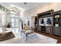 Spacious living room with large windows, a cozy fireplace, and hardwood flooring at 8704 Ingleton Ct, Orlando, FL 32836