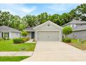 Inviting single-Gathering home boasts a neat front yard, neutral color scheme and attached garage at 907 Pearly Ridge Ln, Lakeland, FL 33809
