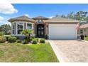Charming single-story home with manicured landscaping, neutral paint, and an inviting double-door entrance at 9426 Burnam Dr, Weeki Wachee, FL 34613