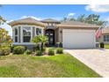 Charming single-story home with manicured landscaping, neutral paint, and an inviting double-door entrance at 9426 Burnam Dr, Weeki Wachee, FL 34613