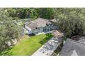 An aerial view showcases the home's layout, landscaping, and proximity to surrounding greenery at 1008 Jackson Creek Ct, Oviedo, FL 32765