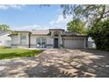 Inviting front exterior with blue door, manicured lawn, and charming details that create excellent curb appeal at 1008 Jackson Creek Ct, Oviedo, FL 32765