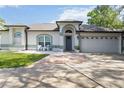 Inviting front exterior with blue door, manicured lawn, and charming details that create excellent curb appeal at 1008 Jackson Creek Ct, Oviedo, FL 32765