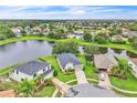 Expansive aerial view showcasing the residential neighborhood, a lake, and the home's prime location at 10836 Tilston Pt, Orlando, FL 32832