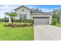 Front of the home features lush landscaping and a two-car garage, offering great curb appeal at 10836 Tilston Pt, Orlando, FL 32832