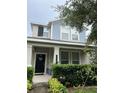 Home exterior with covered porch, manicured landscaping, and stylish facade at 11097 N Folklore St, Winter Garden, FL 34787