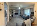 Spacious living room features a ceiling fan, modern furniture, and entertainment center at 114 Madeira Ave, Orlando, FL 32825
