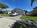 Well-maintained home with a spacious driveway, attached garage, and neatly landscaped front yard at 12938 Maribou Cir, Orlando, FL 32828