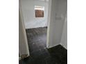 View of a damaged, empty bedroom with peeling paint and damaged floors through a doorway at 134 Flamingo Dr, Auburndale, FL 33823