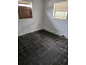 Empty bedroom with damaged walls, peeling paint, and boarded-up windows at 134 Flamingo Dr, Auburndale, FL 33823