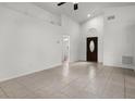 Bright living room with soaring ceilings, neutral paint, and beautiful tile flooring at 142 Stonegate Pass, Davenport, FL 33897