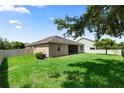 A full shot of the grassy backyard, vinyl privacy fence, and the rear of the home at 1431 Leitrim Loop, Apopka, FL 32703