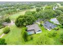 Aerial view of a home next to a golf course, surrounded by mature trees and landscaping at 1507 Golfside Dr, Winter Park, FL 32792