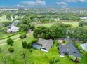 Expansive aerial view of a home and screened in pool, situated on a golf course at 1507 Golfside Dr, Winter Park, FL 32792