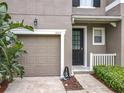Charming townhome exterior with a one-car garage, neutral stucco, and well-maintained landscaping at 2005 Compass Flower Way, Ocoee, FL 34761